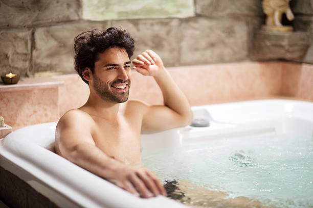 istock Young man enjoying in hot tub. 528217215