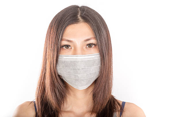 istock Asian woman wearing surgical mask 528218355
