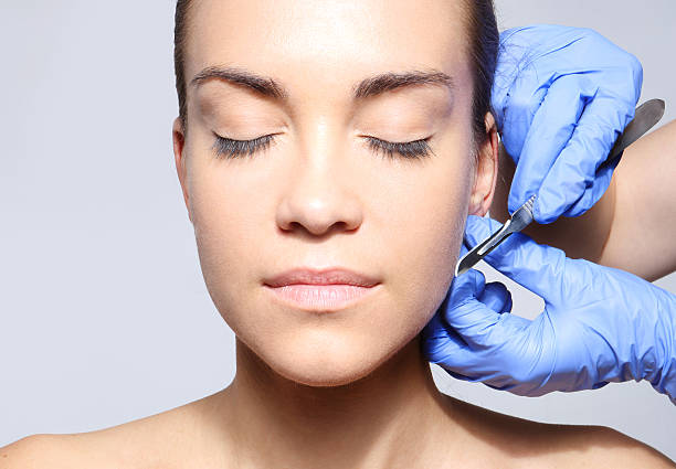 Scalpel, peeling, flaking Caucasian woman during surgery using a scalpel scalpel photos stock pictures, royalty-free photos & images