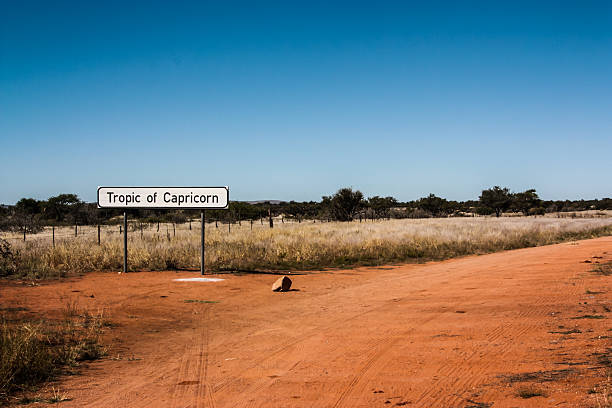 Tropic of Capricorn A sign marks the point where Namibia's B1 highway crosses the Tropic of Capricorn. tropic of capricorn stock pictures, royalty-free photos & images