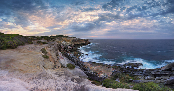 Scenic views north at Cape Solander.  Sydney Australia.  You would not want to have been standing on the cliff ledges when it gave way and crumbled onto the lower rock shelf and ocean