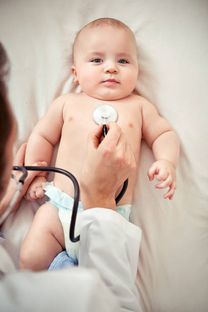 istock baby portrait and pediatrician check 528242175