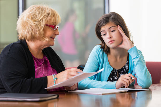 istock Junior high school counselor or therapist meeting with upset student 528242261