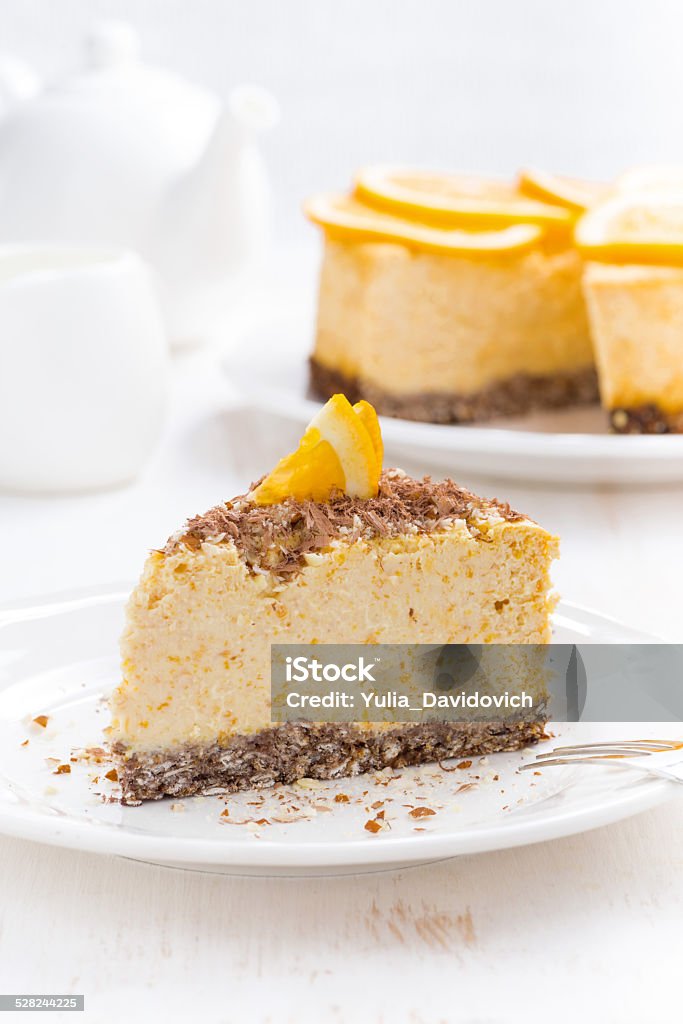 piece of orange cheesecake on a plate, vertical piece of orange cheesecake on a plate, vertical, close-up Backgrounds Stock Photo