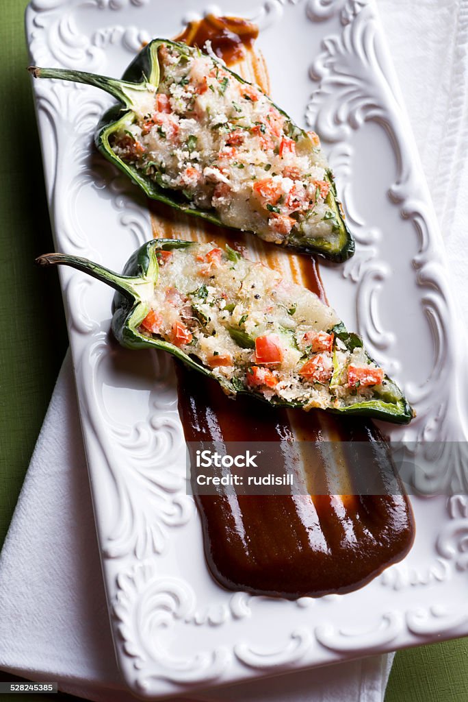 Stuffed Poblano Peppers Poblano Peppers Stuffed with Tomato, Cilantro, Panko Bread Crumbs and Cheese. Appetizer Stock Photo