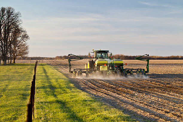 Near Ashland, Illinois, USA - April 14, 2016. Farmer uses modern tractor and corn planter to plant corn in early evening light of central Illinois