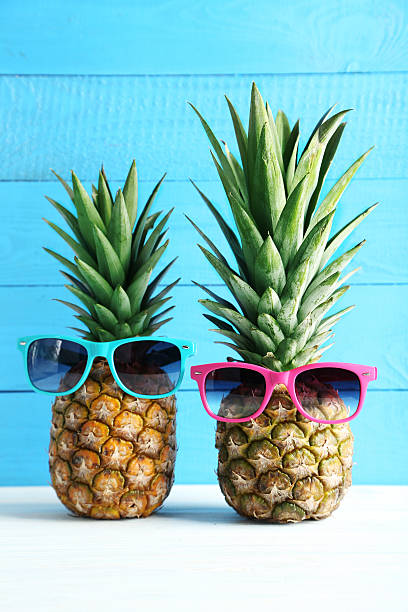 istock Ripe pineapples on a white wooden table 528283804