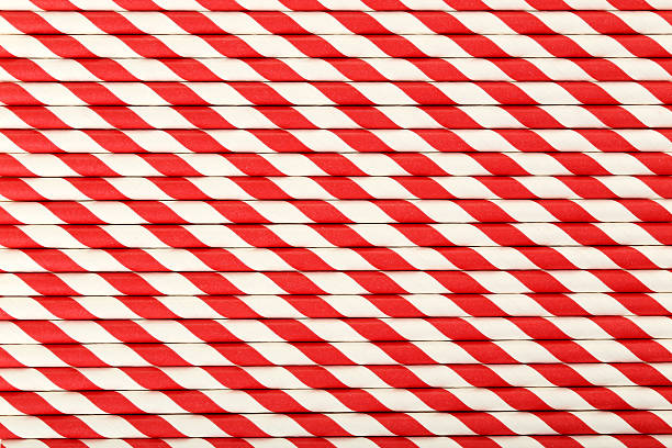 istock Striped drink straws background, close up 528284140
