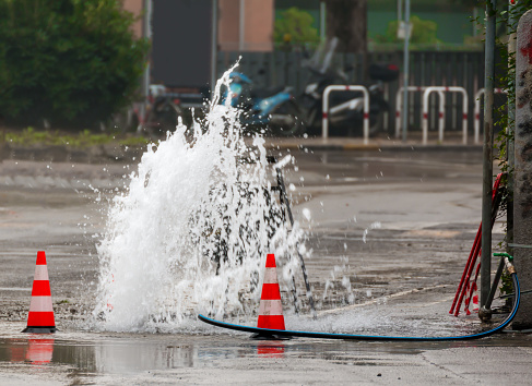 road spurt water beside traffic cones