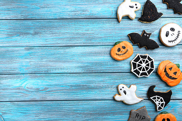 istock Fresh halloween gingerbread cookies on blue wooden table 528287826