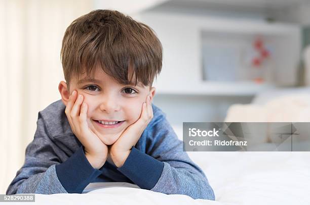 Cute Boy Lying On Bed Stock Photo - Download Image Now - Boys, Child, Smiling