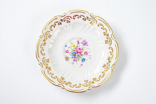 antique plate with floral pattern and decorative rim