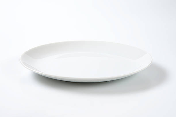 Coup shaped white plate stock photo