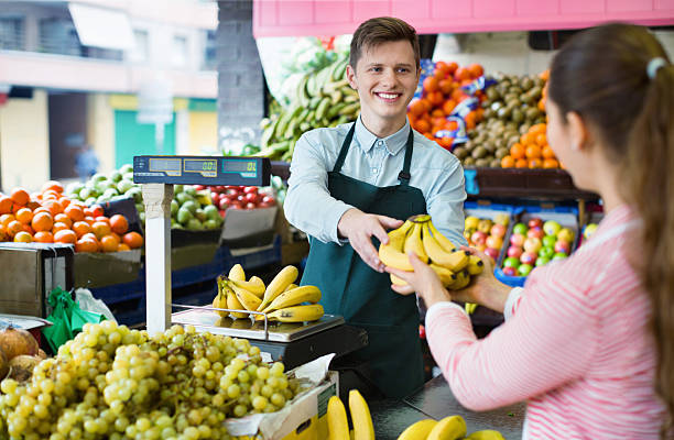 istock Young woman customer buying yellow bananas 528291302