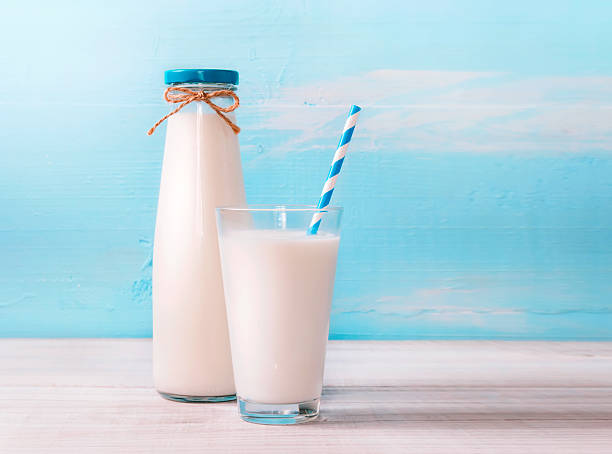 istock Glass nilk bottle on wooden background empty space. 528294754