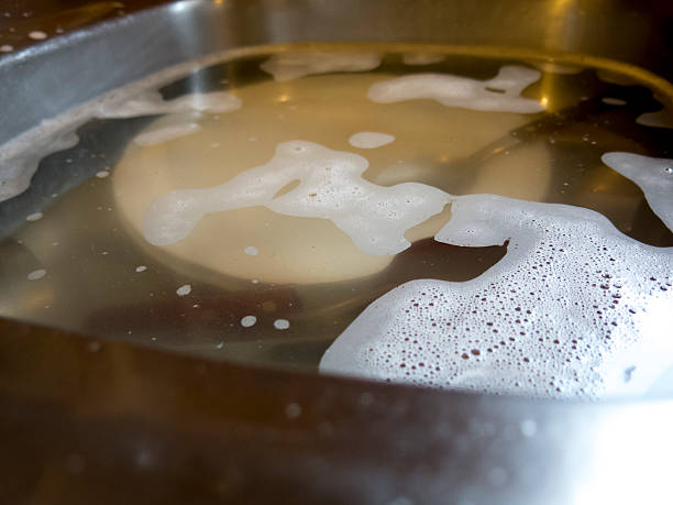 istock Dirty dishes soak in water 528295416