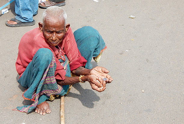 Hyderabad,India- September 22,2014:Poor Indian homeless woman seeking help begging on a busy road
