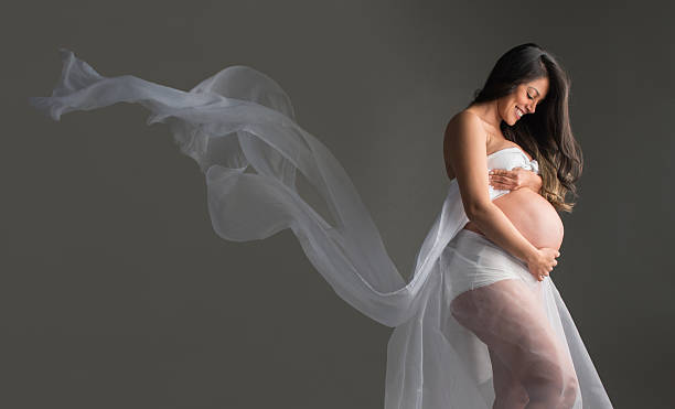 Beautiful pregnant woman Artistic portrait of a pregnant woman enjoying her pregnancy and looking beautiful veil photos stock pictures, royalty-free photos & images