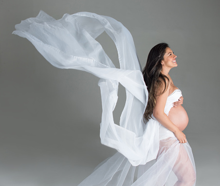 Pregnant woman looking very happy with her pregnancy and wearing a beautiful outfit