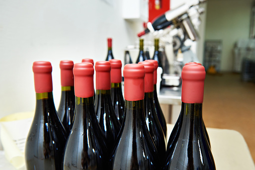 Bottles of wine in the factory after sealing with paraffin