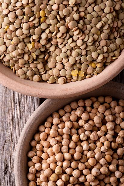 istock Two clay bowls full of chickpeas and lentils 528302588