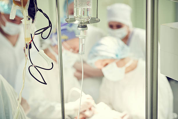 istock surgery and surgical operation. Mediacal dropper with anesthetics 528303640
