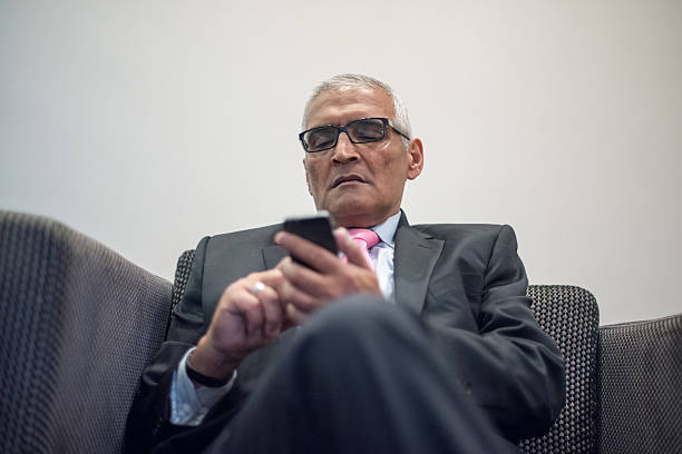 istock Indian Business man on smart phone text messaging 528306300