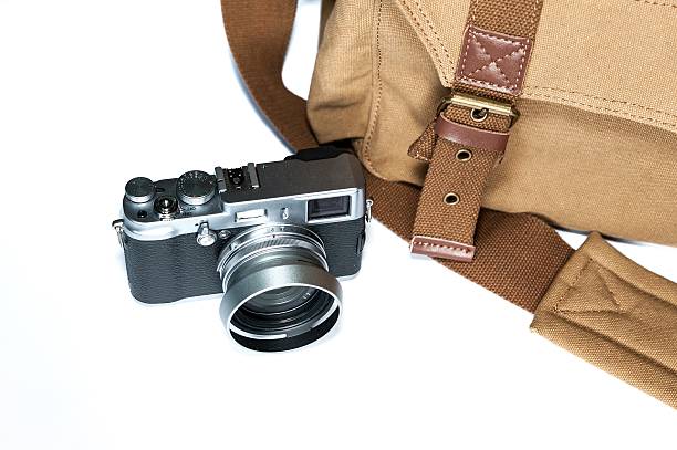 istock Street photographer's camera and camera bag isolated on white. 528311325