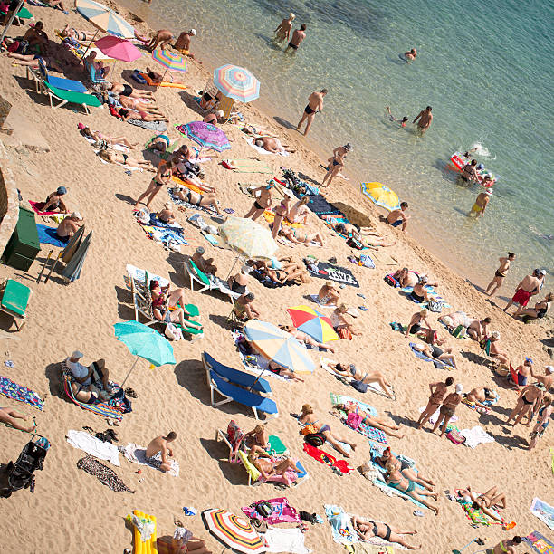 istock People and sun umbrellas on the beach 528312143