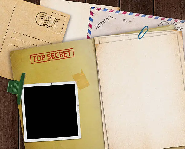 folder with TOP SECRET stamped across the front page and a blank photograph