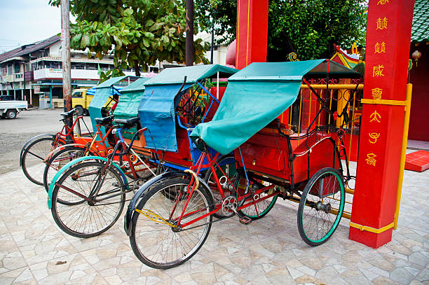 Indonesian Petty Cabs parked near a temple in Pontianak, Indonesia on the Island of Borneo.
