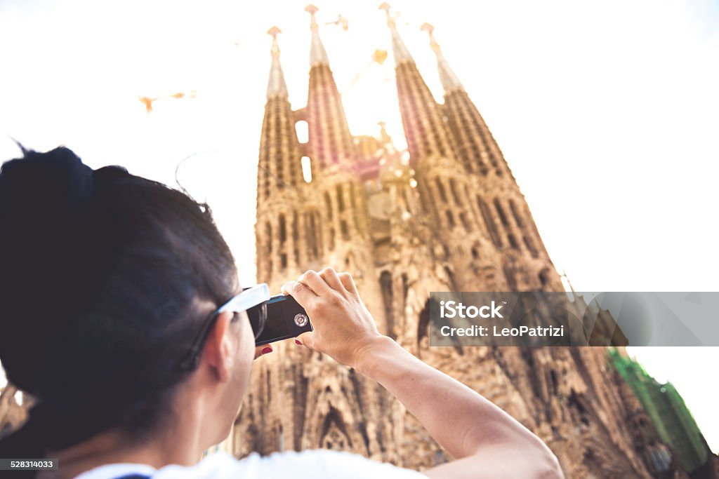 Tourist taking pictures to Sagrada Familia Tourist taking pictures to Sagrada Familia in Barcelona. Adult Stock Photo