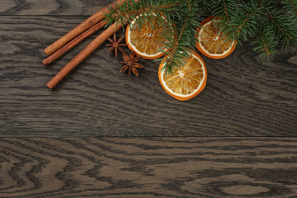 christmas background with cinnamon anise and oranges, oak table