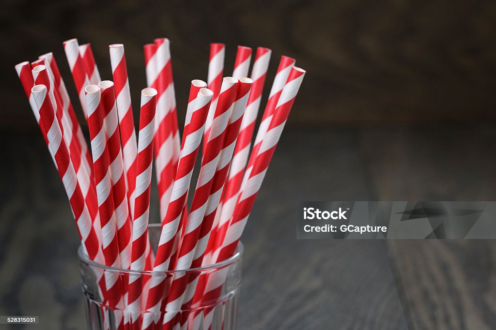 vintage paper straws in glass on wood table vintage paper straws in glass on wood table, rustic style Drinking Straw Stock Photo