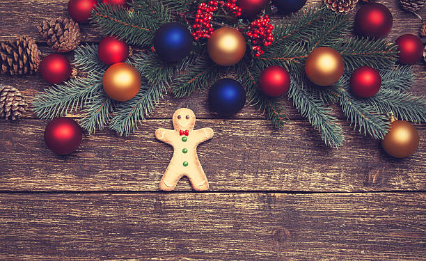 istock gingerbread man with pine branch on a wooden table 528315133