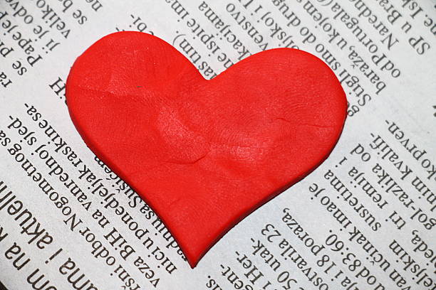 istock Red valentine heart made with plasticine on newspaper 528315357