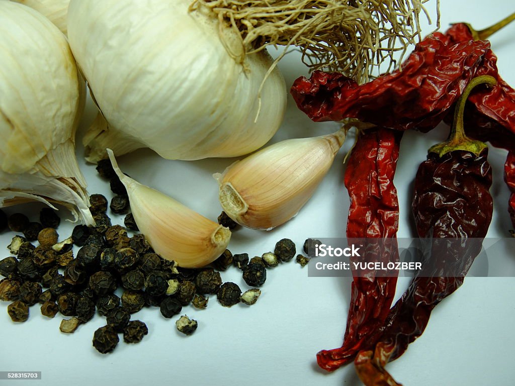 Whole Garlic with Black and Red Peper. Whole Garlic and cloves with Black and Red pepper on white background. Black Peppercorn Stock Photo