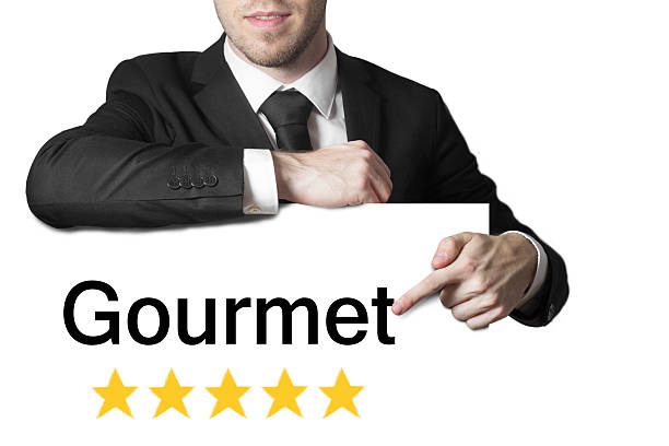 istock businessman pointing on sign gourmet five stars 528316325