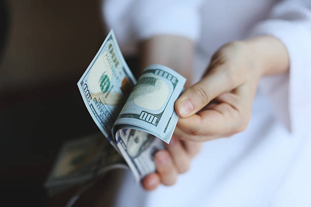 istock Dollars. Money in the hands 528316423