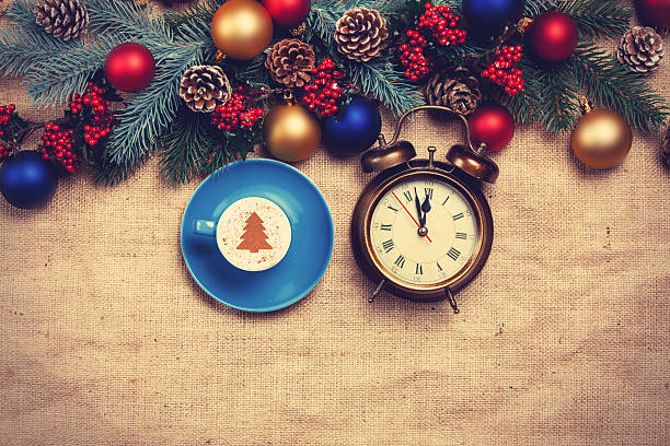 istock Hot cappuccino with christmas tree shape and alarm clock 528316765