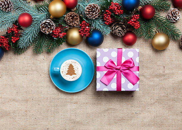 istock Hot cappuccino with cookie and pine on a jute background 528317459