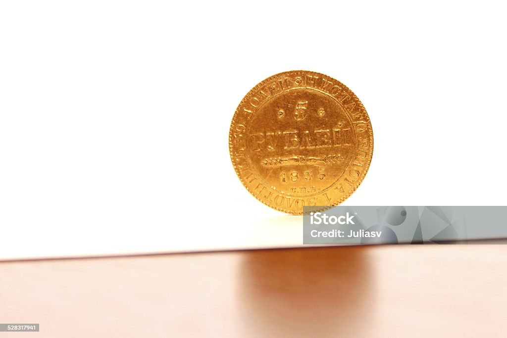Ancient gold coin Ancient gold coin closeup upright on a white background Aging Process Stock Photo