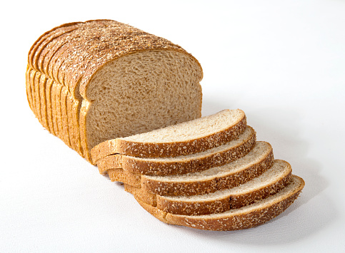 Sliced multi-grain bread on white background