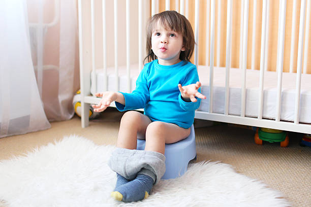 Little boy on potty Lovely 2 years boy sitting on potty potty toilet child bathroom stock pictures, royalty-free photos & images