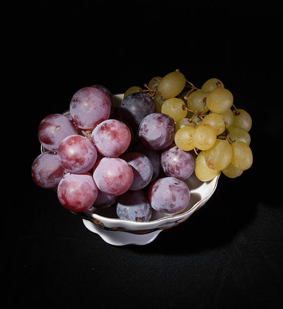 istock vase with grapes on a black background 528318889