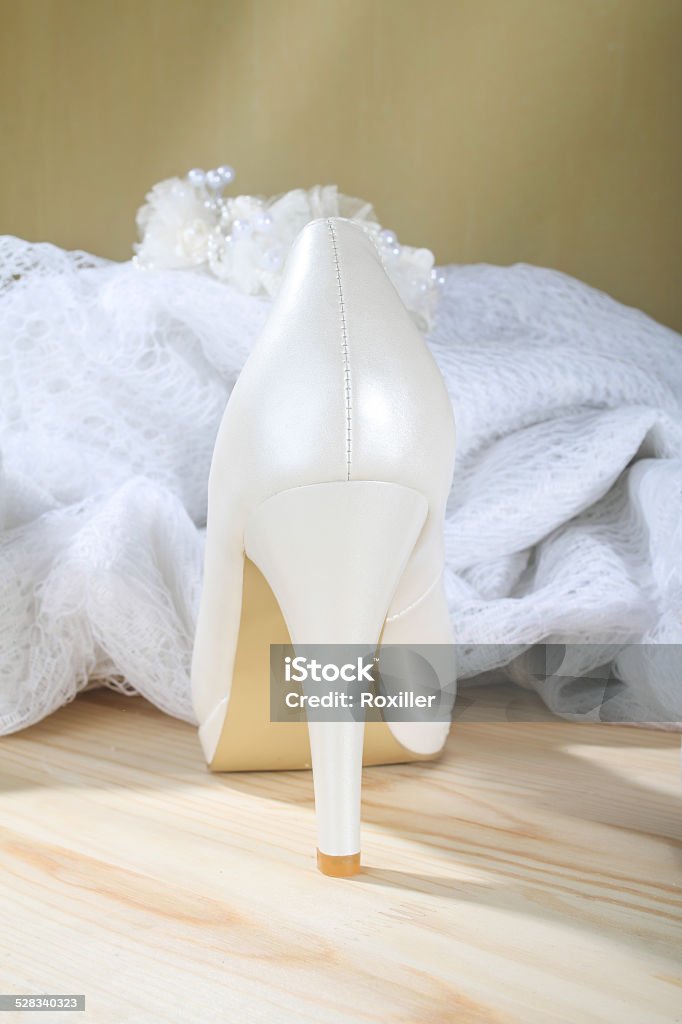 white wedding shoes heel White bridal wedding shoes next to decorative lace Adult Stock Photo