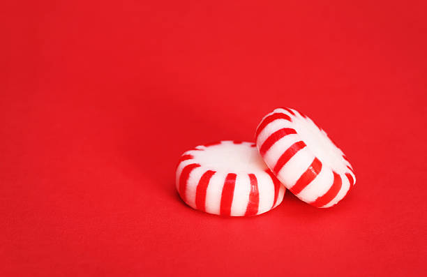 Peppermint Candy over Red Christmas background Peppermint Candy over Red Christmas background. Macro. peppermints stock pictures, royalty-free photos & images
