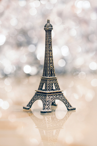 Miniature Eiffel-tower with defocused spot lights in background