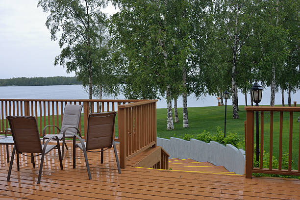 Lake, pleasure boats and garden furniture on a wooden pier.
