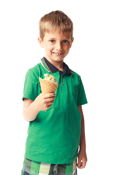 istock Little boy eating ice cream isolated on white 528344263